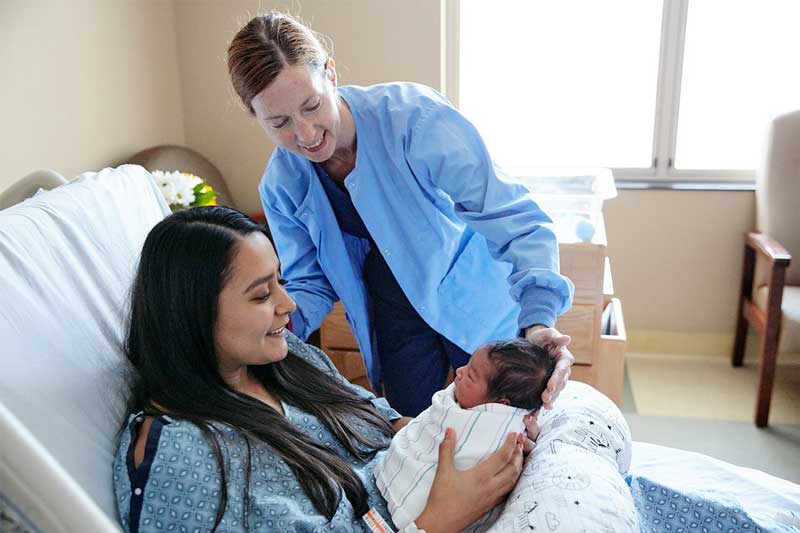 patient holding a newborn