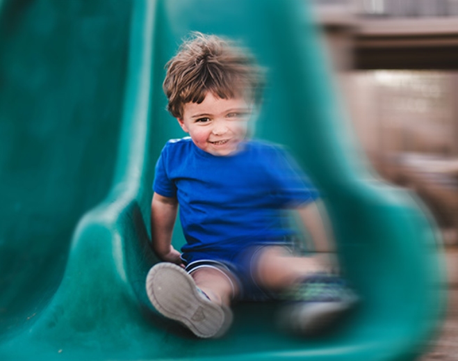Little boy on slide