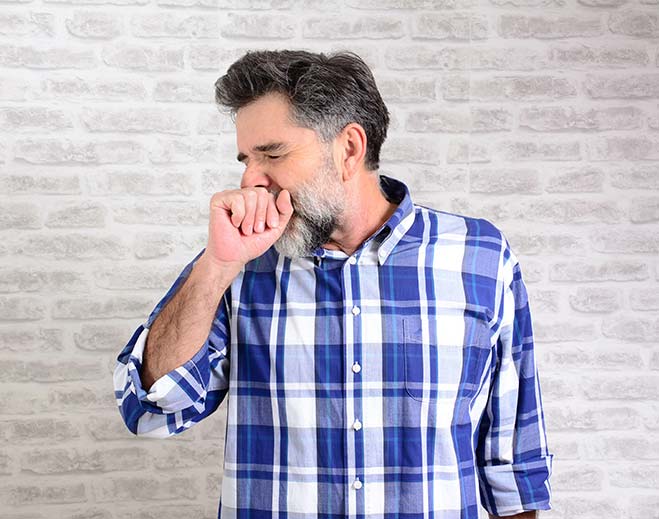 man coughing