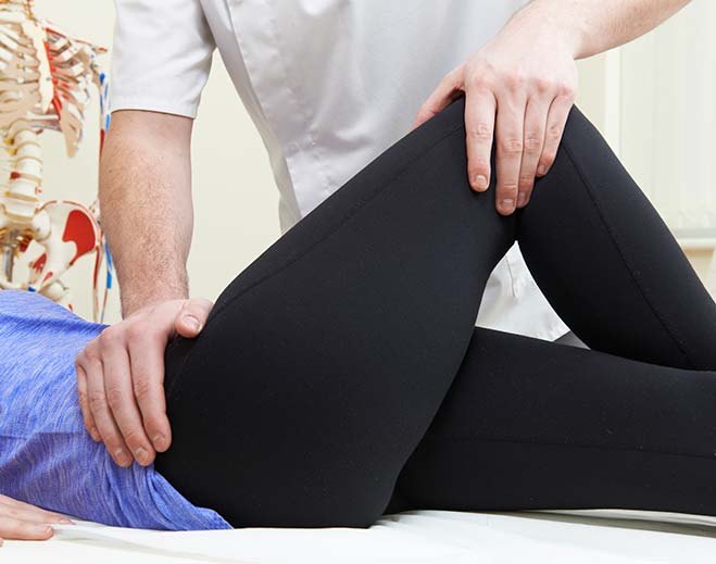 therapist stretching patient's knee